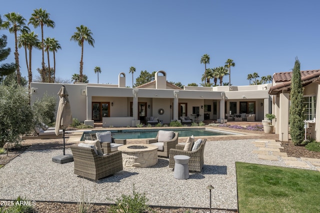 pool featuring a patio area and an outdoor fire pit