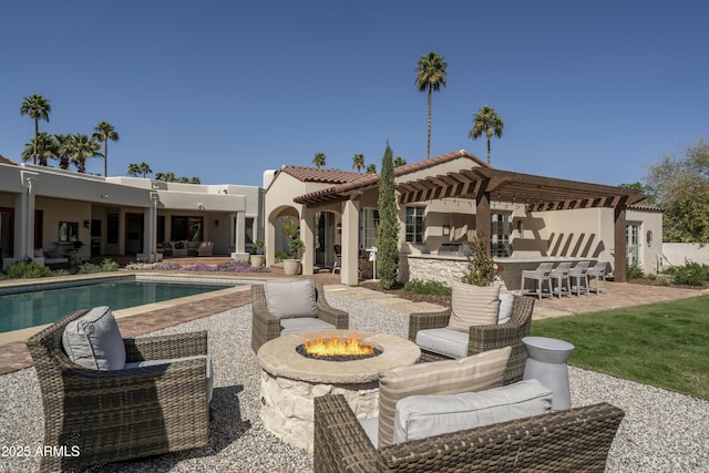 view of patio / terrace with an outdoor living space with a fire pit and an outdoor pool