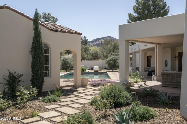 view of patio featuring a fenced in pool, a mountain view, and fence