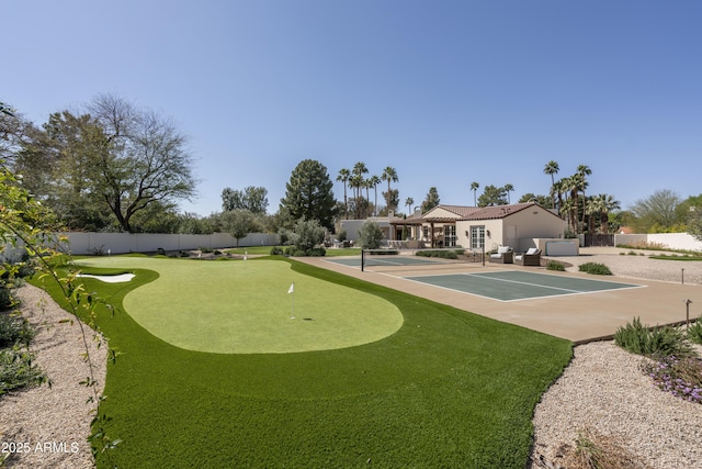 view of community with a fenced backyard and a patio area