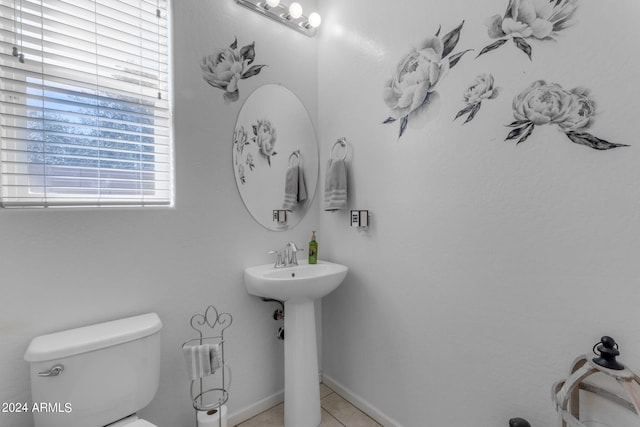 bathroom with tile flooring, sink, and toilet