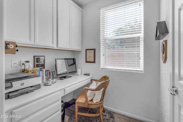 office space with built in desk and hardwood / wood-style flooring