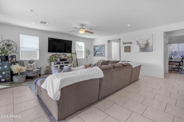 tiled living room with ceiling fan