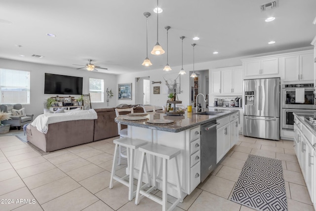 kitchen featuring white cabinetry, appliances with stainless steel finishes, sink, a center island with sink, and ceiling fan