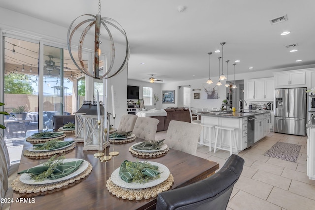 tiled dining room with sink and ceiling fan