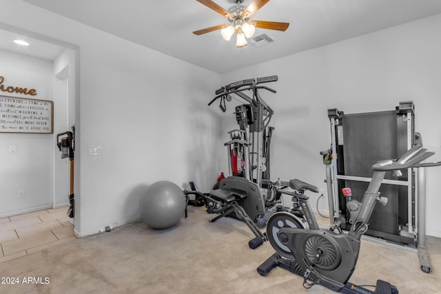 exercise room featuring ceiling fan and light tile floors