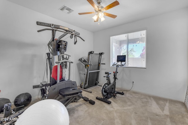 workout room with light carpet and ceiling fan