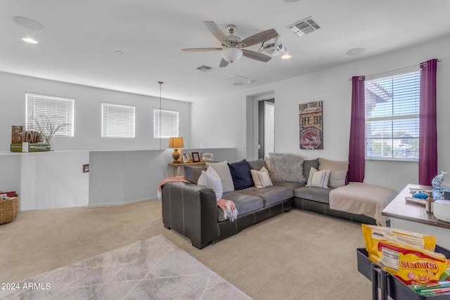 carpeted living room featuring ceiling fan