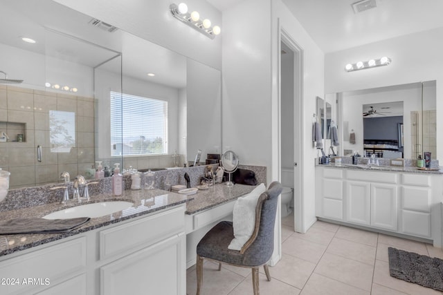 bathroom featuring ceiling fan, dual bowl vanity, and tile flooring