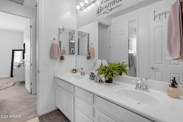 bathroom featuring dual vanity