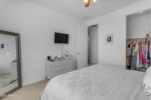 bedroom featuring a closet, ceiling fan, and light colored carpet