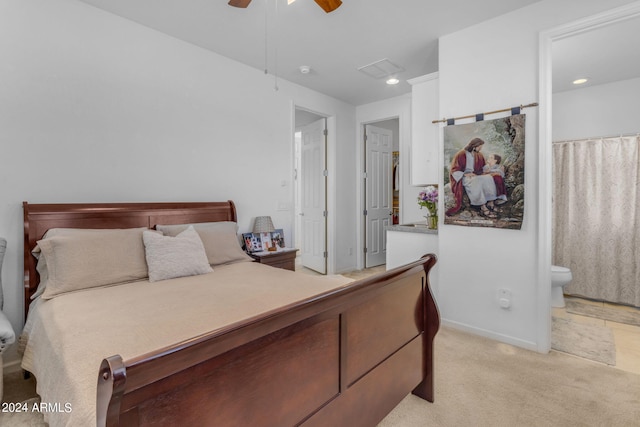 bedroom featuring connected bathroom, ceiling fan, and light tile flooring