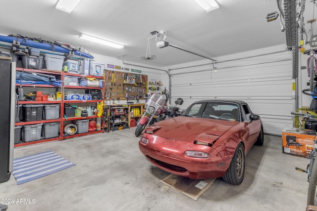 garage featuring a garage door opener and a workshop area