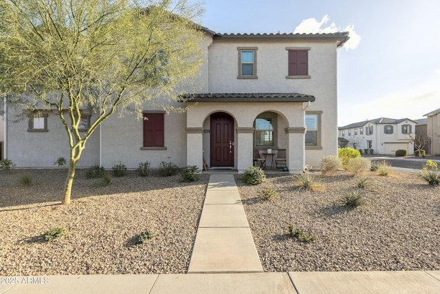 mediterranean / spanish-style house with stucco siding and a tile roof