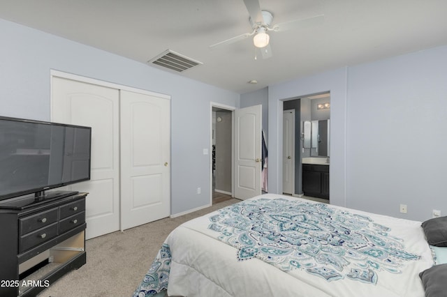 carpeted bedroom with ceiling fan, connected bathroom, and a closet