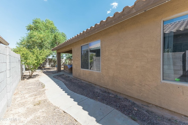 view of side of property featuring a patio area