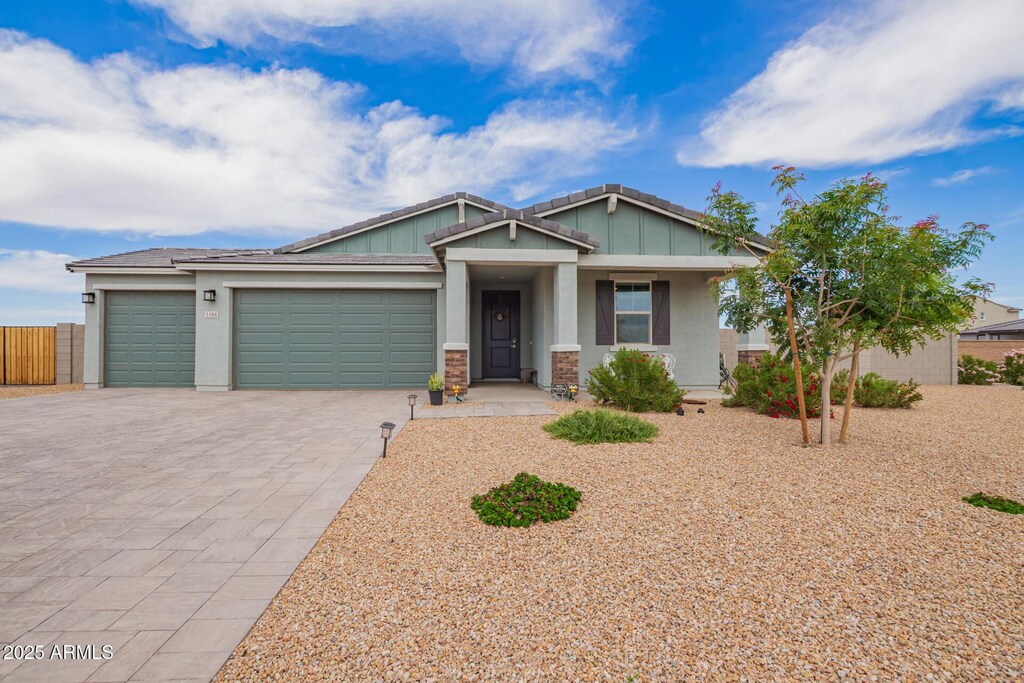 1388 E Tuscany St, Casa Grande, AZ 85122 - craftsman-style house with fence, board and batten siding, decorative driveway, stucco siding, and a garage