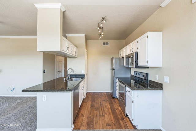 5401 E Van Buren St Unit 3048, Phoenix, AZ 85008 - kitchen featuring appliances with stainless steel finishes, a sink, white cabinets, dark stone countertops, and crown molding