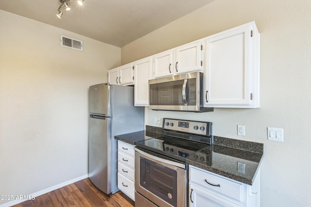 5401 E Van Buren St Unit 3048, Phoenix, AZ 85008 - kitchen with stainless steel appliances, white cabinets, dark stone countertops, and dark wood-type flooring