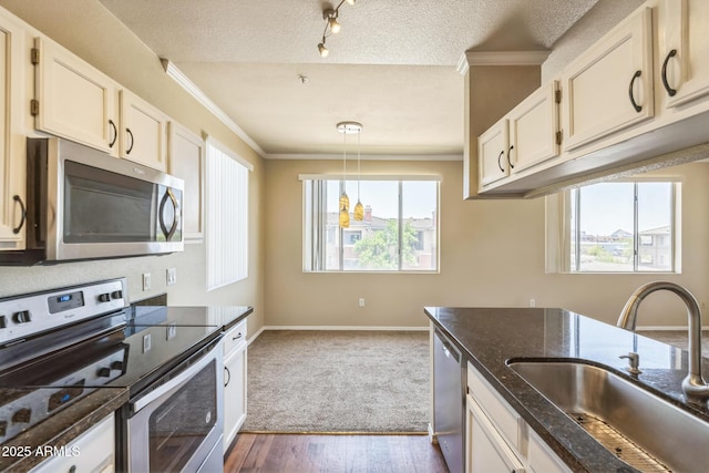 5401 E Van Buren St Unit 3048, Phoenix, AZ 85008 - kitchen with stainless steel appliances, a sink, ornamental molding, dark stone countertops, and decorative light fixtures