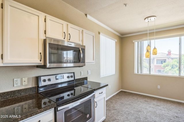 5401 E Van Buren St Unit 3048, Phoenix, AZ 85008 - kitchen with appliances with stainless steel finishes, ornamental molding, white cabinets, light colored carpet, and pendant lighting