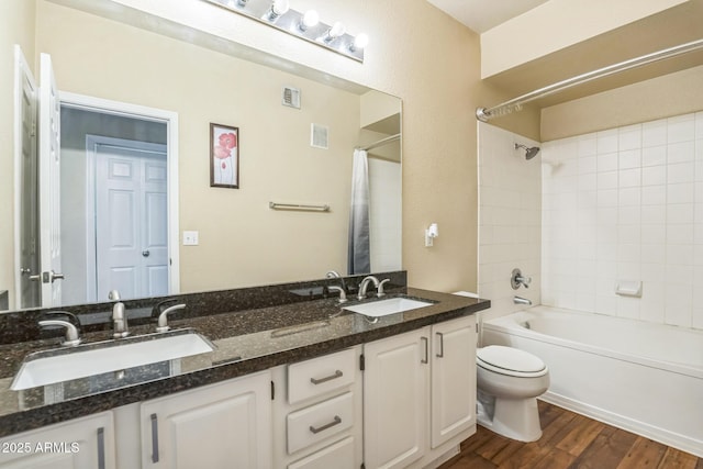 5401 E Van Buren St Unit 3048, Phoenix, AZ 85008 - bathroom featuring toilet, double vanity, wood finished floors, and shower / tub combo