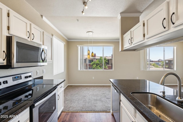 5401 E Van Buren St Unit 3048, Phoenix, AZ 85008 - kitchen with appliances with stainless steel finishes, a sink, ornamental molding, white cabinets, and hanging light fixtures