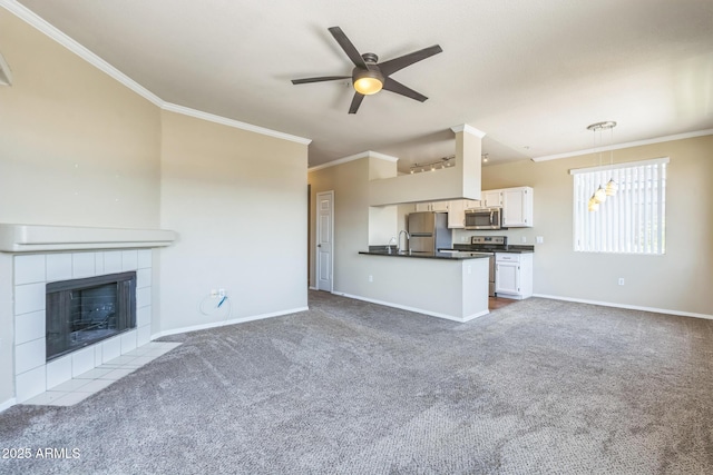 5401 E Van Buren St Unit 3048, Phoenix, AZ 85008 - unfurnished living room with carpet flooring, a ceiling fan, crown molding, baseboards, and a tile fireplace