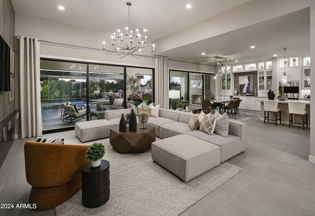 living room with recessed lighting, an inviting chandelier, and light tile patterned floors