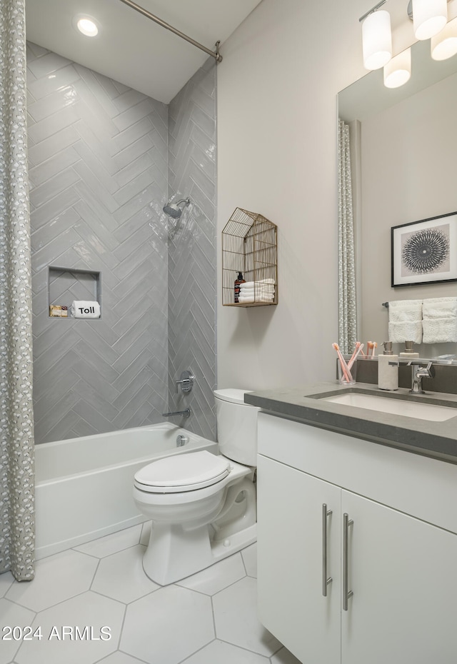 bathroom with tile patterned flooring, toilet, vanity, and shower / bath combo with shower curtain