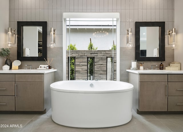 bathroom featuring tile patterned flooring, tile walls, and a freestanding tub