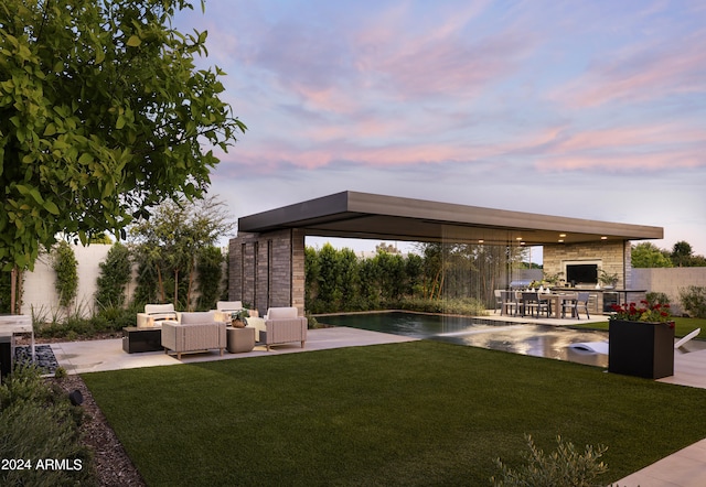 view of yard with a patio, fence, and an outdoor hangout area