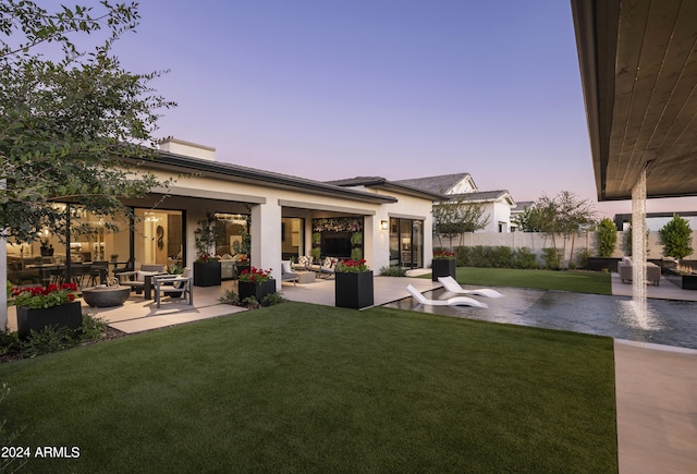 yard at dusk with a patio and fence