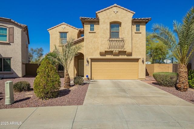 mediterranean / spanish-style house featuring stucco siding, driveway, and fence