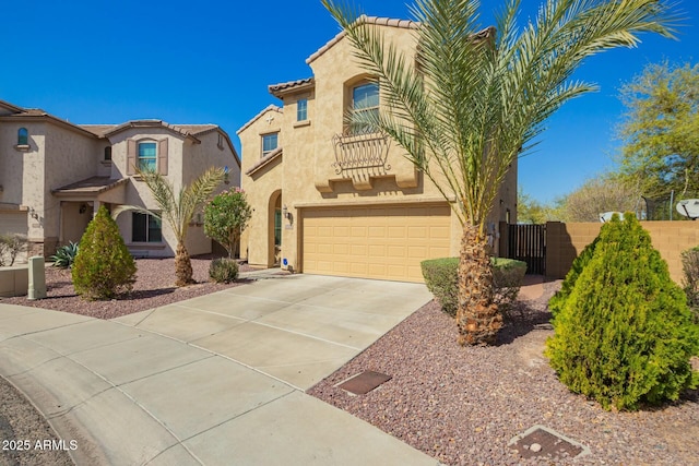 view of front of property with a gate, an attached garage, stucco siding, concrete driveway, and a tile roof