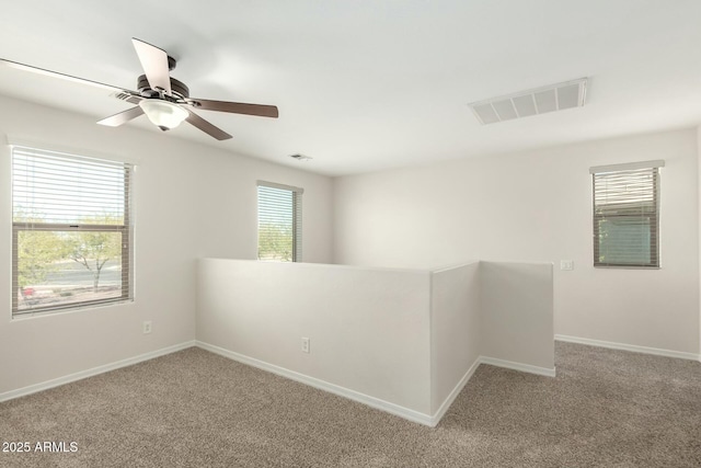 unfurnished room featuring baseboards, visible vents, and carpet floors