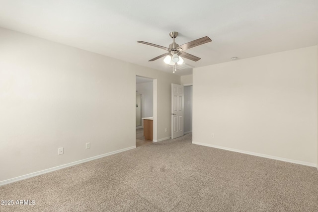 spare room with light carpet, ceiling fan, and baseboards