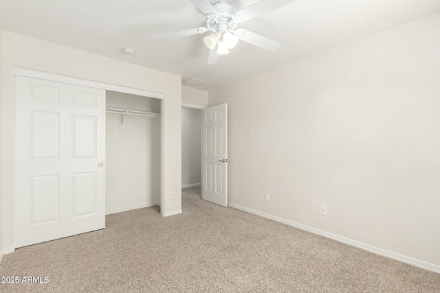 unfurnished bedroom with a closet, baseboards, ceiling fan, and carpet flooring