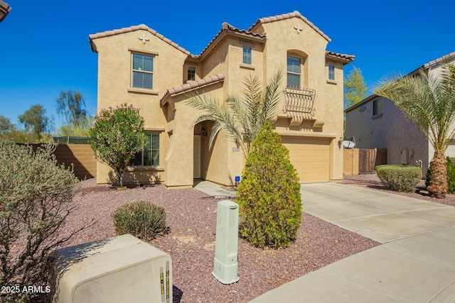 mediterranean / spanish-style house featuring concrete driveway, an attached garage, fence, and stucco siding