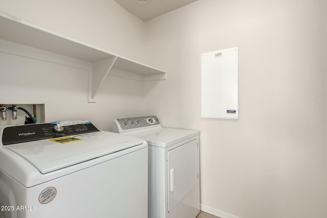 laundry area with baseboards, separate washer and dryer, and laundry area