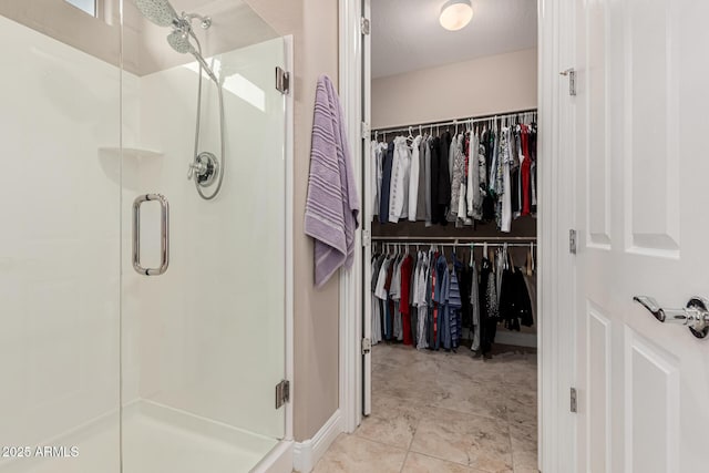 bathroom featuring a textured ceiling and walk in shower