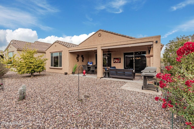 rear view of house featuring a patio area, ceiling fan, and an outdoor living space