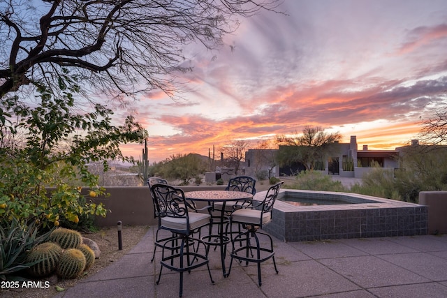 view of patio terrace at dusk