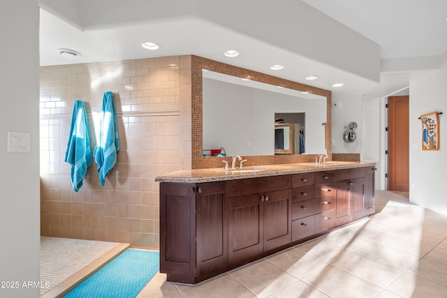 bathroom with double vanity, recessed lighting, a sink, and tile patterned floors