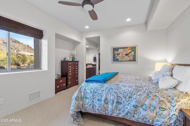 bedroom featuring visible vents, ensuite bath, ceiling fan, carpet flooring, and recessed lighting