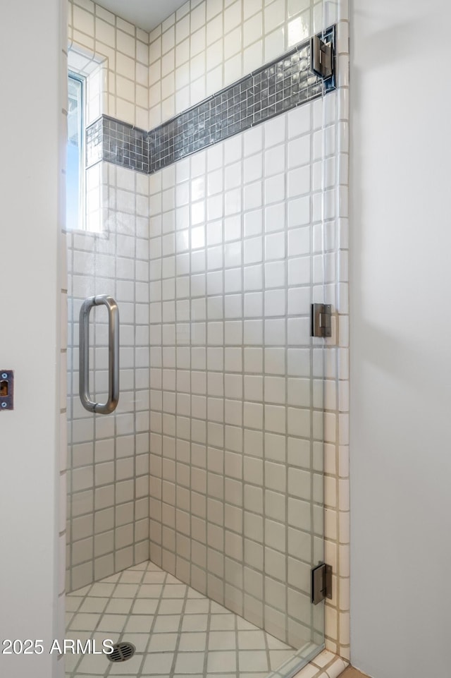 full bath featuring a shower stall