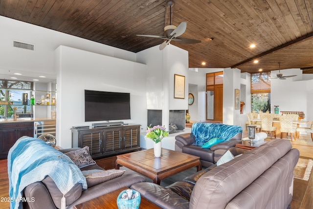 living area featuring wine cooler, wooden ceiling, wood finished floors, visible vents, and wet bar