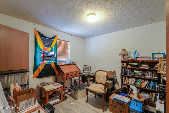 sitting room featuring a textured ceiling and wood finished floors