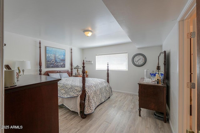 bedroom with baseboards and light wood-style floors