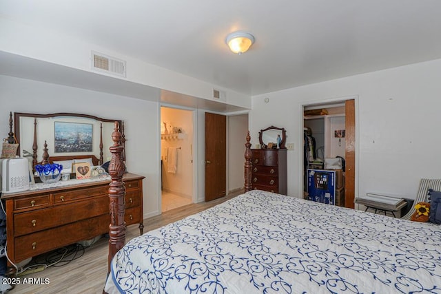 bedroom featuring light wood-style floors and visible vents